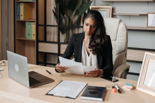 Businesswoman in suit at desk, focused on work